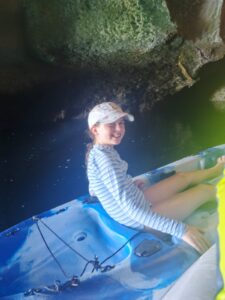 A young kayaker exploring Cathedral Cave near El Nido